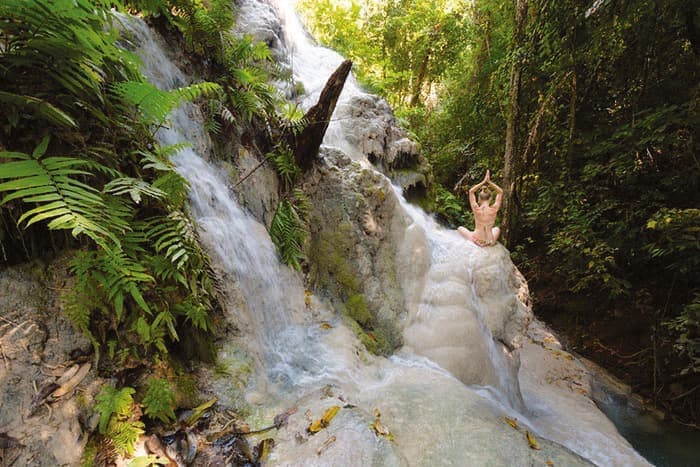 A guest posing on the Sticky Waterfall